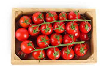 Obraz premium Cherry tomato bunch in a wooden box isolated on white background. Top view. Flat lay