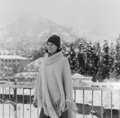 Winter in Batoumi. A young woman smiling with a snowy landscape in the background. Georgia - February 2025. 