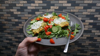 Zucchini Fritters with Tzatziki, Cucumbers, Cherry Tomatoes, and Arugula