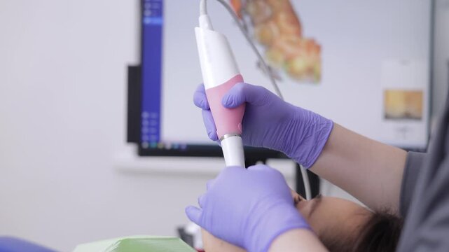Young asian female receiving dental treatment with modern equipment technology 3D scanner.