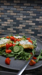 Zucchini Fritters with Tzatziki, Cucumbers, Cherry Tomatoes, and Arugula