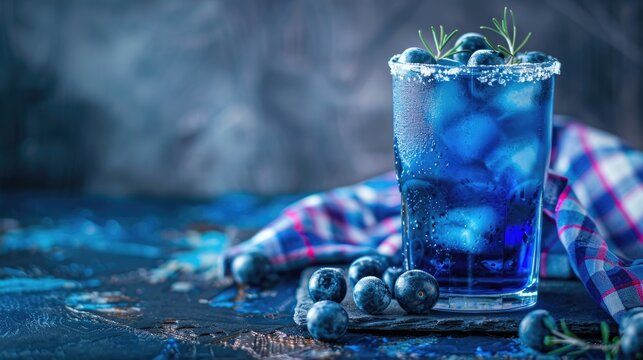 Horizontal banner for Scotland National Day celebration showing blue chilled cocktails with blueberries and rosemary garnish. Festive drink arrangement with copy space, free space for text