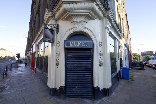 Edinburgh, United Kingdom - 08 July 2016: View of La Cerise cafe with its contrasting dark shutters and cream corner facade, nestled on a street corner.