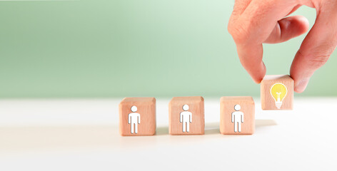 Wooden blocks with symbol of human resource management and recruitment concept.