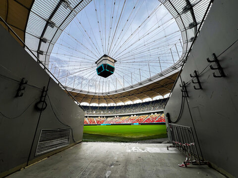 Massive Soccer Stadium tunnel.View of empty stadium. Green grass on a sport Arena. Empty Football Soccer Stadium Tribune. National arena with empty seats. Sport event on National Arena. 