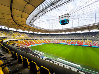 Massive Soccer Stadium Filled. Wide view of empty stadium. Green grass on a sport Arena. Empty Football Soccer Stadium Tribune. National arena with empty seats. Sport event on National Arena. 