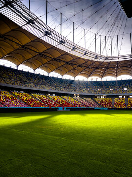 Massive Soccer Stadium Filled. Wide view of empty stadium. Green grass on a sport Arena. Empty Football Soccer Stadium Tribune. National arena with empty seats. Sport event on National Arena. 