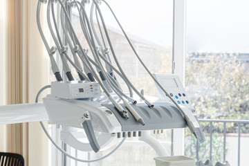 Dental equipment, doctor's unit,module, in a bright clinic, with modern technology, no people, natural light