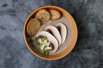 Creamy Mushroom Soup With Toasted Bread Slices Garnished With Fresh Herbs