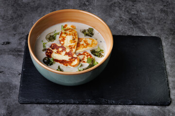 Creamy Cheese Soup, Garnished with Herbs and Melted Cheese