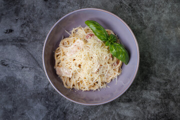 Creamy Spaghetti with Parmesan, Basil Garnish, and Olive Oil in a Purple Bowl