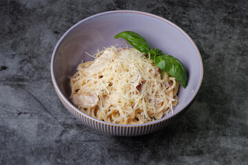 Creamy Spaghetti with Parmesan, Basil Garnish, and Olive Oil in a Purple Bowl