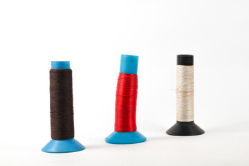 colorful thread spools in brown, red, and beige, ideal for sewing projects and creative design inspiration