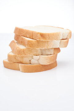Five (5) slices of freshly baked Jamaican hard dough bread isolated on a white background
