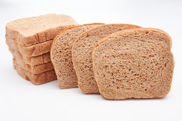 Eight (8) slices of freshly baked Jamaican whole wheat bread isolated on a white background