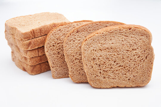 Eight (8) slices of freshly baked Jamaican whole wheat bread isolated on a white background