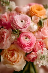 Obraz premium Beautiful Bouquet of Pink and Peach Ranunculus Flowers in Soft Lighting