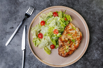 Grilled Chicken and Fresh Romaine Salad on Beige Plate with Cherry Tomatoes - Healthy Dinner Idea