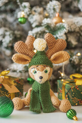 Crocheted Reindeer with Gifts and Christmas Tree in Festive Interior