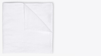 Simple white cloth folded neatly on a light background with a focus on cleanliness and minimalism.