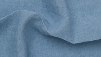 Soft blue fabric draped gracefully on a surface in natural light.