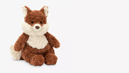 Soft brown and white plush fox toy sits on a plain background looking inviting and cuddly in a cozy space.