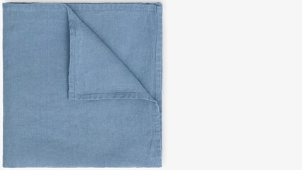 Soft blue textured blanket spread out on a neutral surface in a cozy indoor setting.