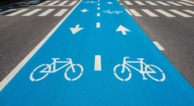High-angle view of blue bike lane on asphalt road