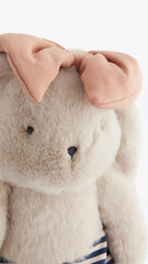 Soft bunny toy with a pink bow, perfect for children's playtime or as a comforting companion.