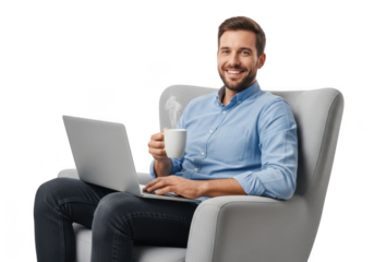 Smiling man holding a coffee cup while working on a laptop seated comfortably in a plush armchair against a black background