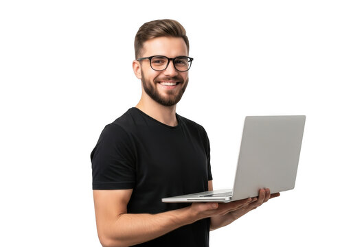 Smiling young man with beard and glasses wearing a black t shirt holding a silver laptop against a stark black background