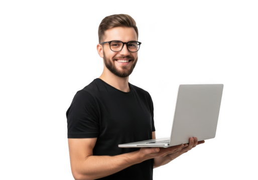 Smiling young man with beard and glasses wearing a black t shirt holding a silver laptop against a stark black background