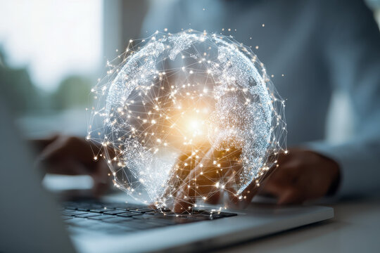 Innovative digital globe with interconnected data points glowing above a laptop keyboard symbolizing global technology and network connectivity in modern business