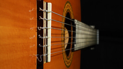 Beautiful close-up of a classical guitar showcasing its strings and body in intricate detail.