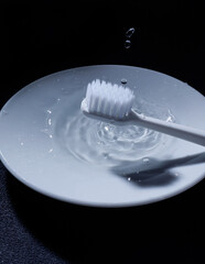 The toothbrush of water on a black background