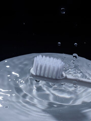 white toothbrush with water drop splash