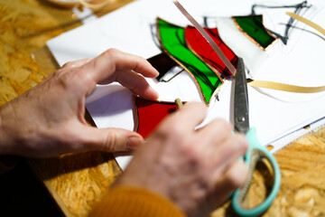 Making stained glass during artistic workshop. 