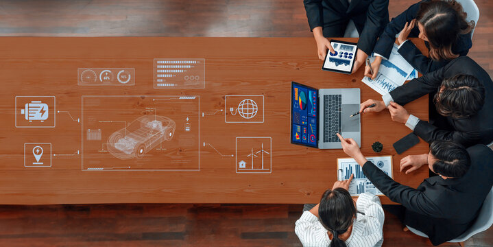 A diverse team engages in collaboration within a modern workspace, utilizing digital interfaces and data analytics to strategize and innovate solutions effectively. Trope