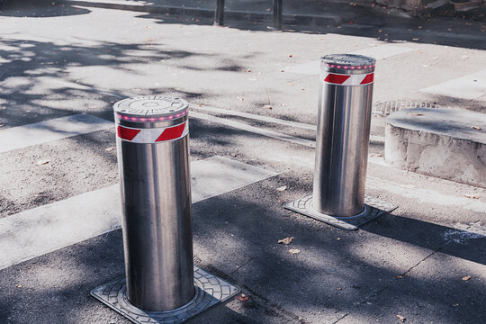 Two stainless steel security bollards with flashing lights provi