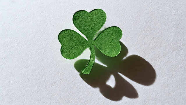 Stylized Shamrock Cutout in Green Paper Casting Clean Shadow on White