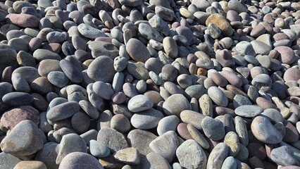 Serene pebble beach landscape with smooth stones. Horizontal banner. Copy space. Stone background. Travel, vacation concept