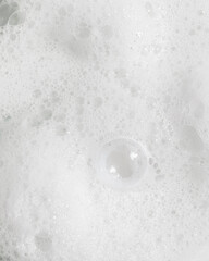 Macro texture photo of white foamy soapy bubbles