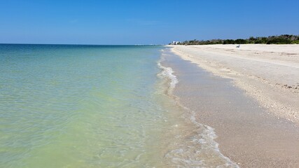 Tropical White Sand Shoreline with Calm, Clear Waves.