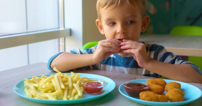 Child Enjoying Chicken Nuggets and Fries at Cafe