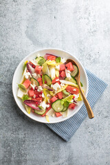 Fresh chicory Endive salad with watermelon, cucumber, and feta cheese, top view.