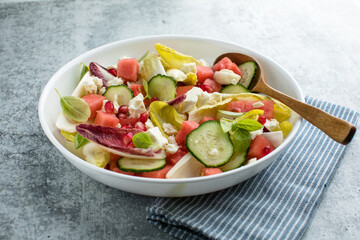 Fresh chicory Endive salad with watermelon, cucumber, and feta cheese, top view.