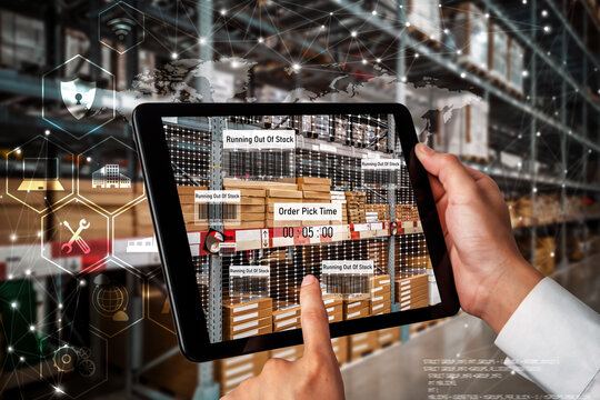 Smart warehouse management system using augmented reality technology to identify package picking and delivery . Future concept of supply chain and logistic business .