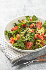 Broccoli Salad with Grapefruit and Cilantro on Gray Background