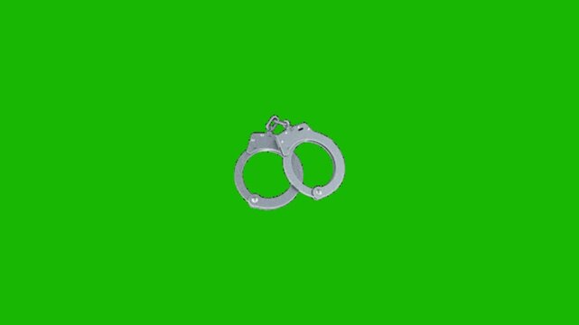 Police handcuff on green background