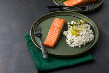 Cooked salmon fllets with rice  on green background